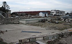 Ruins of residential area in the Lower 9th Ward, with ING 4727 barge in the background