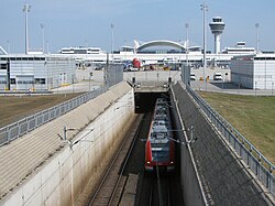 A S-Bahn train leaving the tunnel beneath the apron of Terminal 1