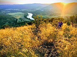 The view from the top of Aasvoëlkop in the heart of the Vredefort impact structure with the Vaal River and Venterskroon on its right in the background
