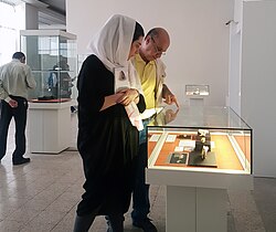 Visitors examining fossils displayed at the National Museum of Iran in Tehran, Iran
