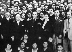 In 1931, during the establishment ceremony of the Turkish History Institution. Atatürk is standing with Afet İnan (on his left) and Yusuf Akçura (first from the left).