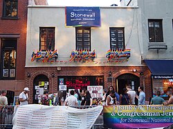 Greenwich Village, a gay neighborhood in Manhattan, is home to the Stonewall Inn, shown here adorned with rainbow pride flags.[8][9][10]