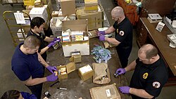 U.S. Food and Drug Administration agents inspect packages for illegal drug shipments at an international mail facility in New York.