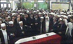 People praying during the funeral