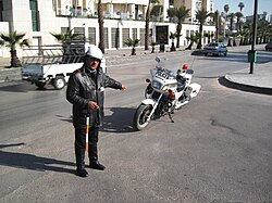 A traffic police officer carries out traffic in downtown Damascus.