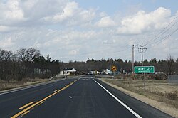 Looking north along Wisconsin Highway 173 at the community's border road sign, March 2012