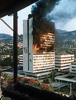 The parliament building of Bosnia and Herzegovina burning amid the Yugoslav wars
