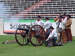 The Texas Cowboys fire Smokey the Cannon during a football game.
