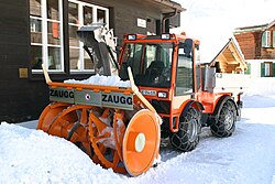 A Zaugg snow blower fitted with snow chains