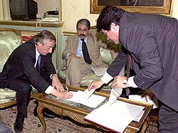 President Néstor Kirchner (left) signs the order removing Mrs. Juárez from her post as Governor of Santiago del Estero while Aníbal Fernández watches