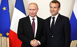 Macron shakes hands with Russian President Vladimir Putin in May 2018.