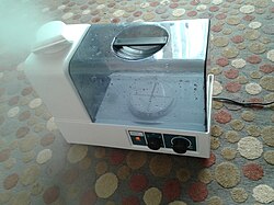 An ultrasonic humidifier with a bottom filled tank that has a replaceable demineralization unit (see inside bottom)