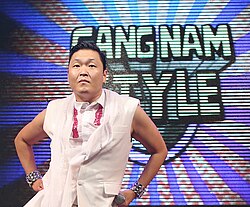 Psy with the "Gangnam Style" logo in September 2012