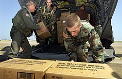 Soldiers load hundreds of Meals, Ready-to-Eat and water onto a CH-47 Chinook helicopter at Ellington Field, Texas