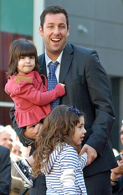 Sandler with his two daughters, Sunny and Sadie, in February 2011, at a ceremony for receiving a star on the Hollywood Walk of Fame