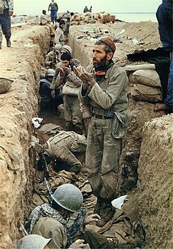 Iranian soldiers praying inside a trench during Operation Karbala-5