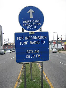 Evacuation route sign on Tulane Avenue in New Orleans shows lines from long-standing flood waters, after Hurricane Katrina.