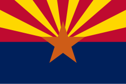 Flag of the state of Arizona. This refers to the Arizonacoalition [nl], a government that initiative takers Georges-Louis Bouchez, Egbert Lachaert, and Joachim Coens tried to form. The bottom half of the flag, coloring blue, refers to the liberal parties MR and Open Vld, the red and yellow rays in the upper half symbolize respectively sp.a and N-VA, and the orange star represents Christian democrat parties CD&V and cdH.
