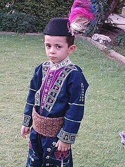 An Assyrian child dressed in traditional clothes