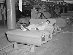 Young striker off sentry duty sleeping on the assembly line of auto seats