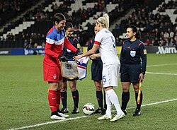 Wambach and England captain Steph Houghton shake hands before kick off on February 13, 2015