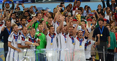 Flick (far left) celebrates the 2014 FIFA World Cup win.