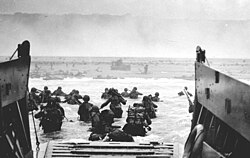 U.S. soldiers departing landing craft during the Normandy landings on 6 June 1944 known as D-Day
