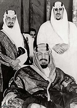 Ibn Saud (seated) with his sons Prince Faisal (left) and Prince Saud in the early 1950s