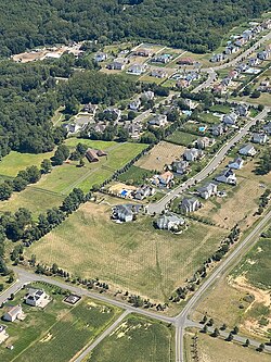 Aerial view of some of the numerous housing tracts of Monroe Township, Middlesex County, New Jersey. Significant new housing construction is rendering an increasingly affluent and suburban environment to Monroe Township, while maintaining the proximity to both New York City and top-ranked Princeton University sought by Indians in this township and the surrounding India corridor of central New Jersey, with the fastest-growing Indian population in the Western Hemisphere.