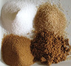 Sugars (clockwise from top-left): white refined, unrefined, brown, unprocessed cane sugar