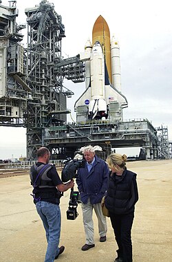 Attenborough filming commentary for a documentary at the Kennedy Space Center in Florida, United States, with Space Shuttle Columbia in the background